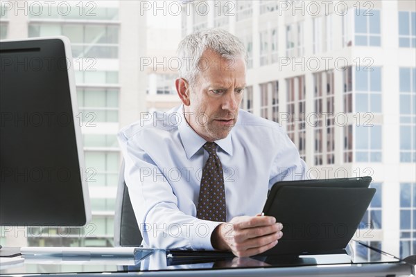 Caucasian businessman using tablet computer