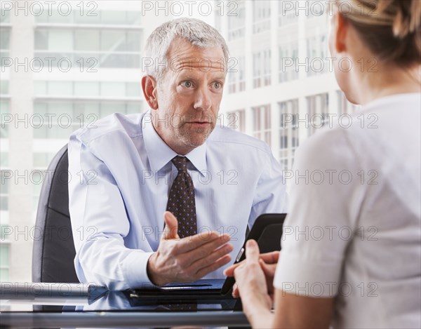 Caucasian businessman talking with client