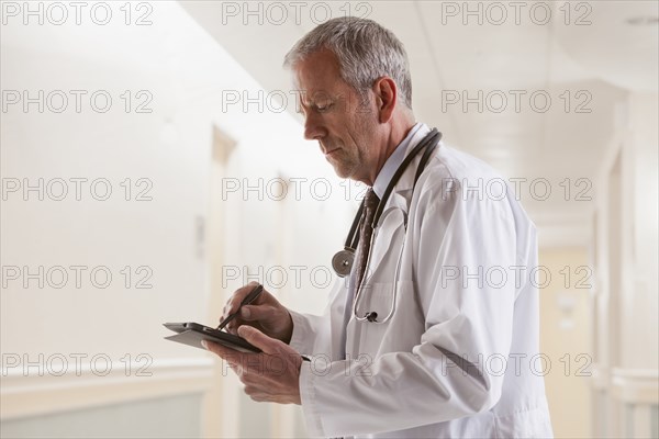 Caucasian doctor using tablet computer