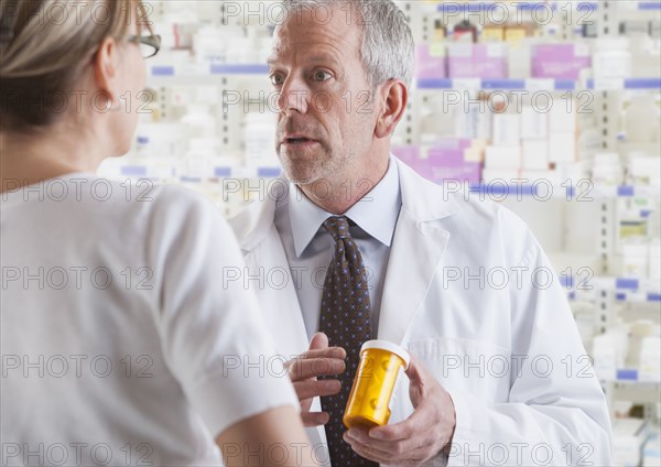 Caucasian pharmacist talking to patient