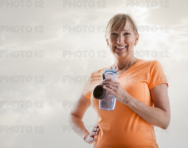 Caucasian woman drinking water bottle