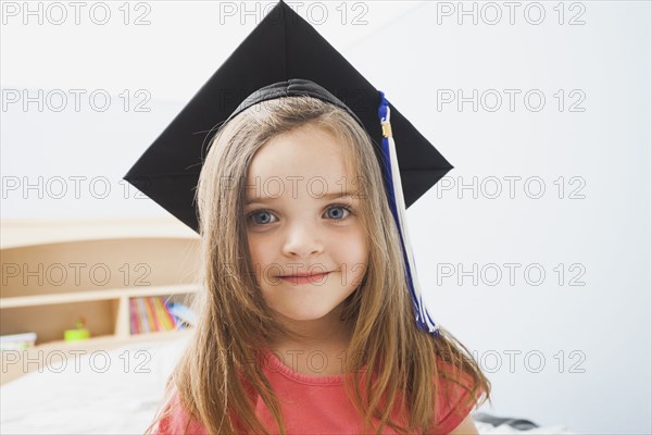 Caucasian girl wearing graduate cap