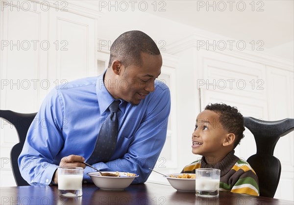 Father and son having breakfast together