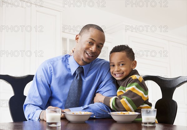 Father and son having breakfast together