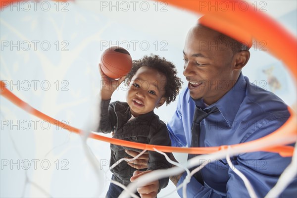 Father and son playing basketball together