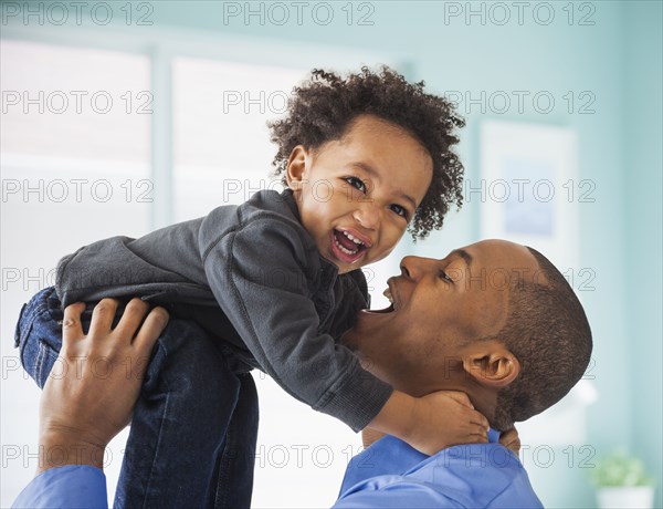 Father and son playing indoors