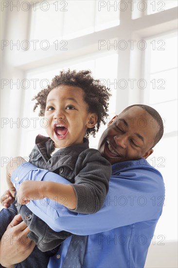 Father and son playing indoors