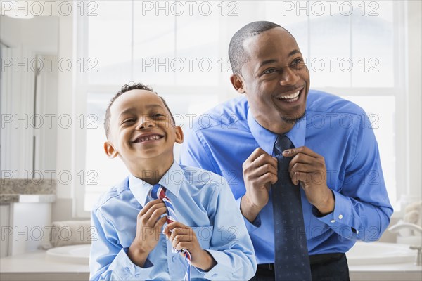 Father and son straightening their ties