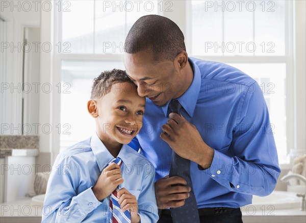 Father and son straightening their ties