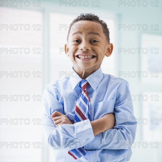 Mixed race boy wearing shirt and tie