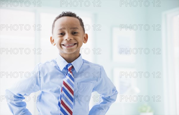 Mixed race boy wearing shirt and tie