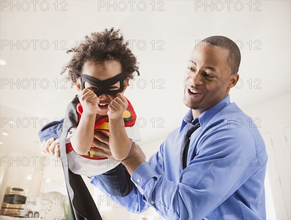 Father and son playing superhero