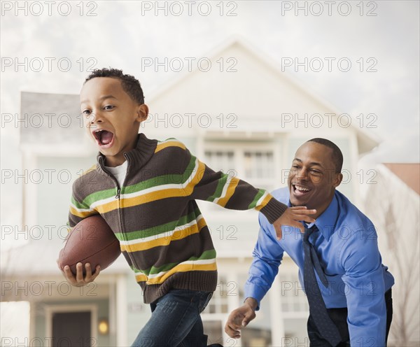 Father and son playing football