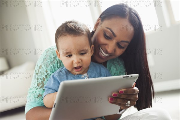 Mother and son using digital tablet