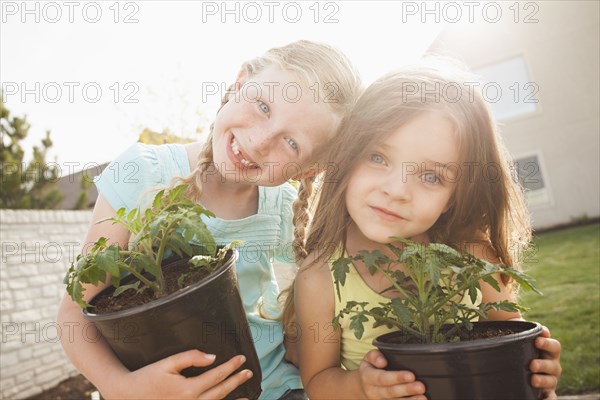 Caucasian girls gardening together