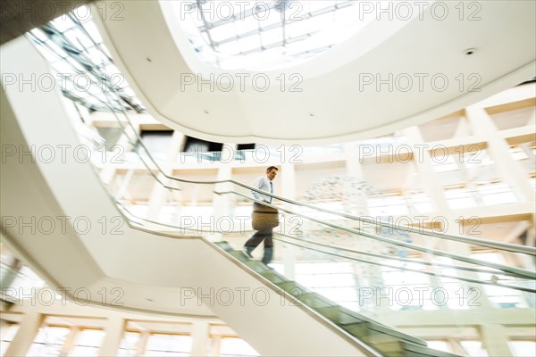 Caucasian businessman rushing on office staircase