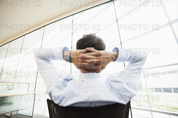 Caucasian businessman relaxing at desk