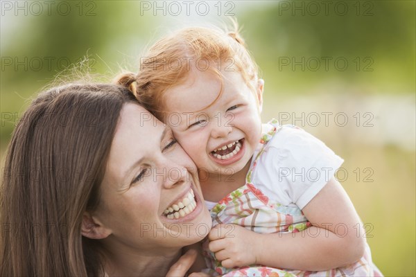 Caucasian mother and daughter playing outdoors