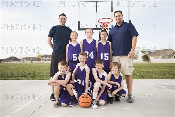 Caucasian basketball team smiling court