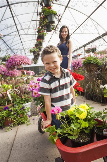 Caucasian mother and son shopping in plant nursery