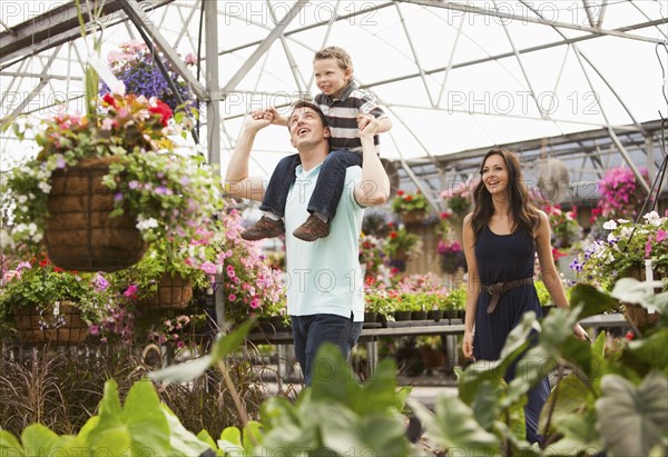 Caucasian family shopping in plant nursery