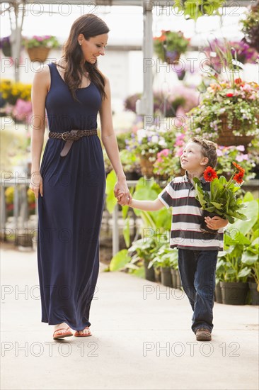 Caucasian mother and son shopping in nursery