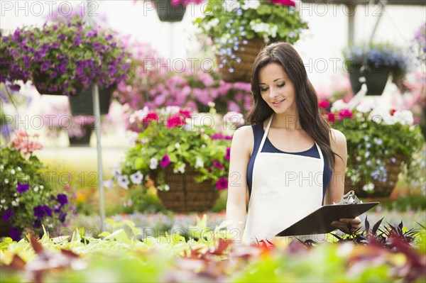 Caucasian woman working in plant nursery