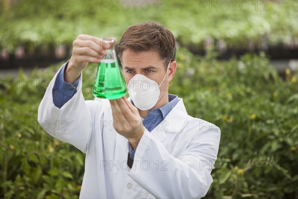 Caucasian scientist working in greenhouse