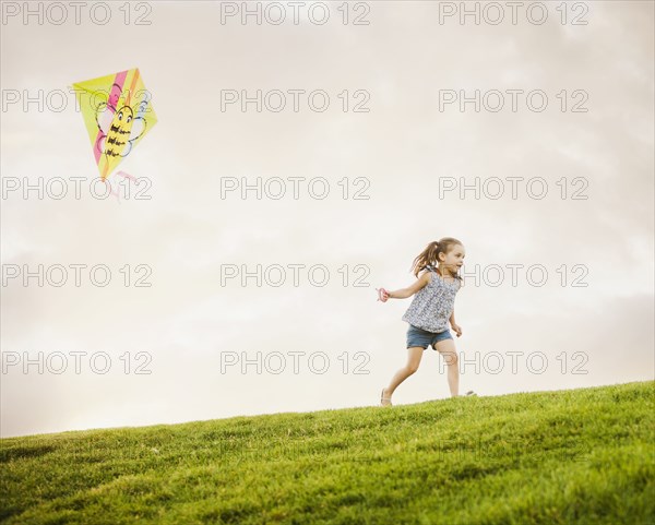 Caucasian girl flying kite