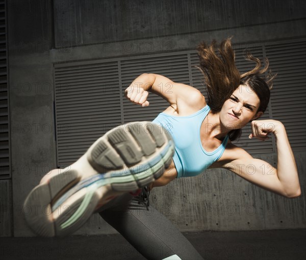 Caucasian woman kicking