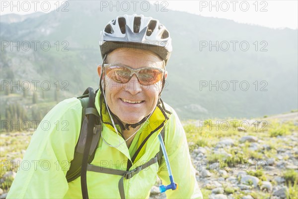 Caucasian man smiling on rocky trail