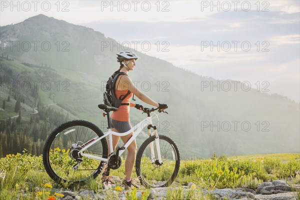 Caucasian woman with mountain bike looking at view