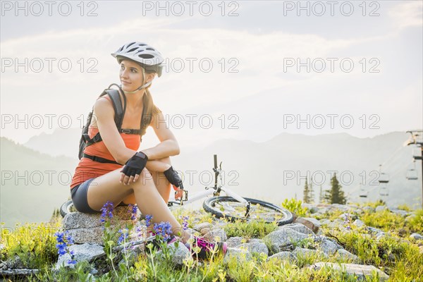 Caucasian woman sitting near mountain bike