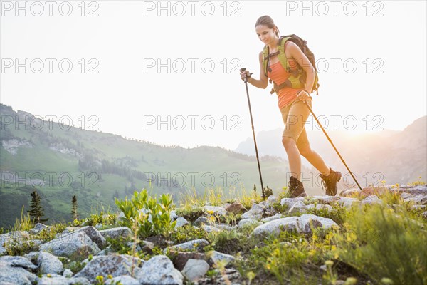 Caucasian woman hiking on rocky trail