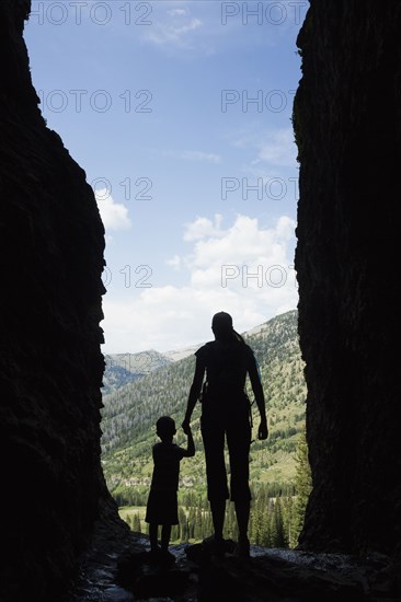 Caucasian mother and son exploring cave