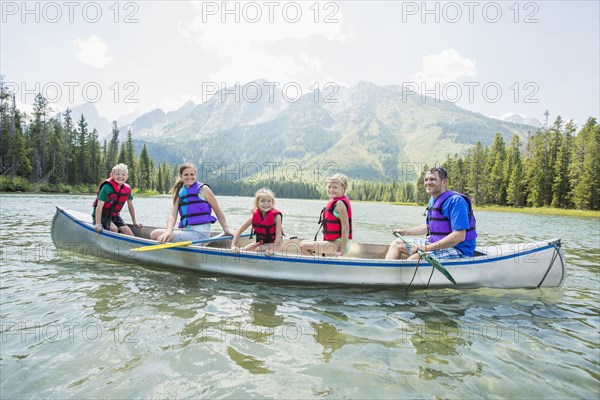 Caucasian family in canoe on lake