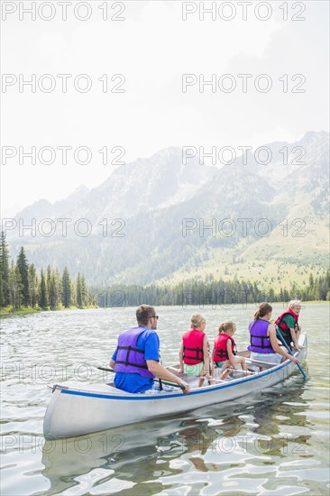 Caucasian family in canoe on lake