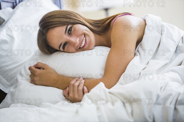 Caucasian woman laying in bed