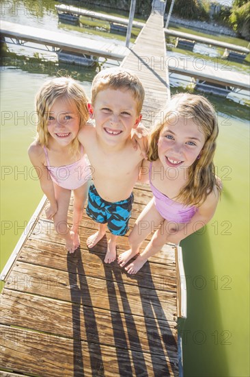 Caucasian children standing on dock