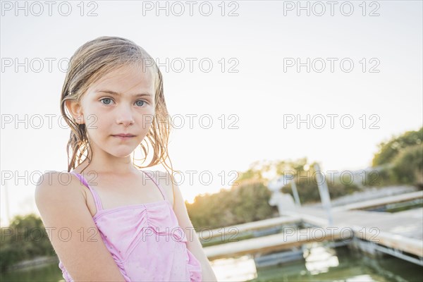 Caucasian girl standing at lakeside