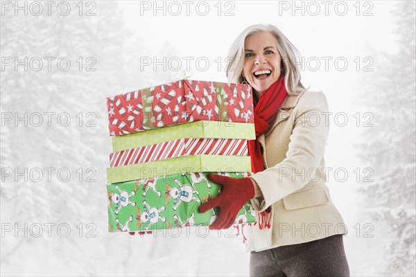 Portrait of enthusiastic Caucasian woman with Christmas gifts