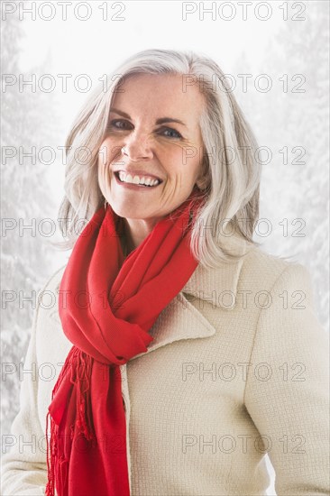 Portrait of smiling Caucasian woman in winter coat and scarf