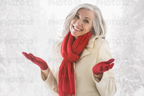Portrait of shrugging Caucasian woman in warm clothing
