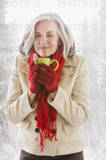 Caucasian woman drinking hot chocolate outdoors