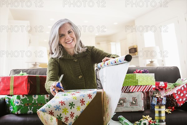 Portrait of Caucasian woman wrapping Christmas gifts