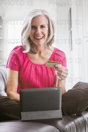 Portrait of smiling Caucasian woman shopping online