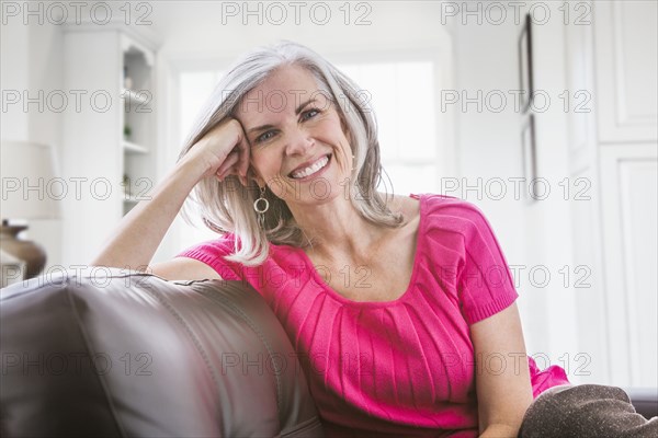 Portrait of smiling Caucasian woman on sofa