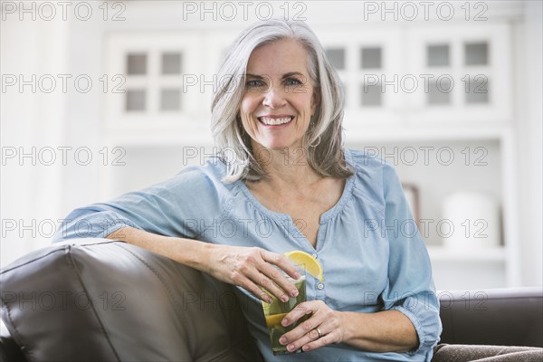 Portrait of smiling Caucasian woman drinking iced tea