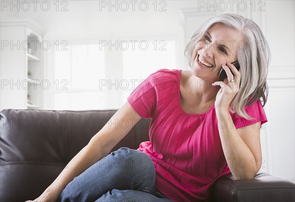 Happy Caucasian woman talking on cell phone