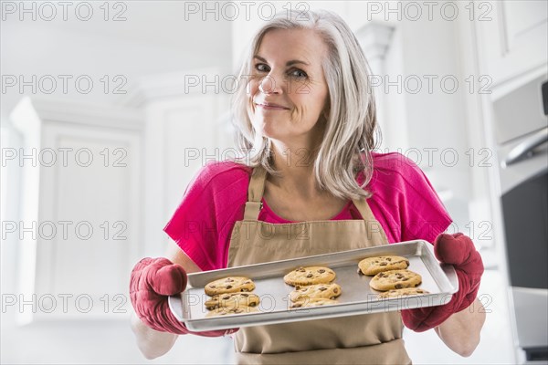 Portrait of Caucasian woman holding baked cookies